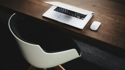 chair by half open laptop and mouse